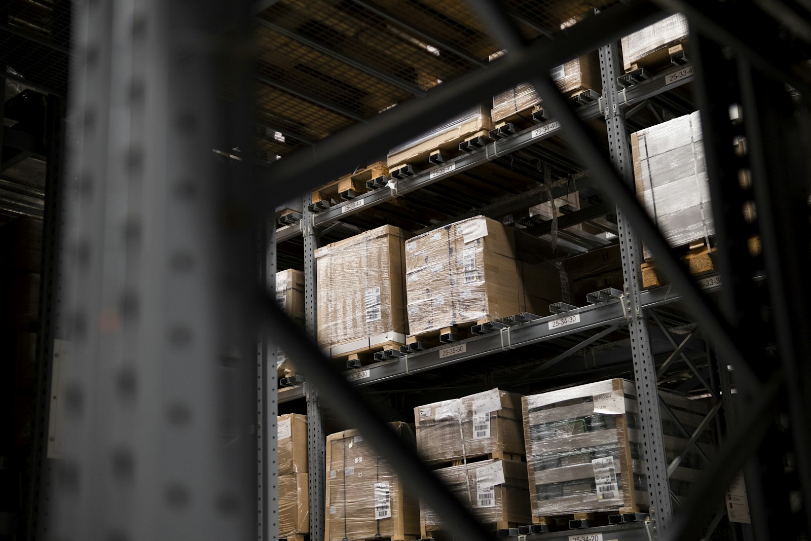 Warehouse racking stacked with cartons and pallets