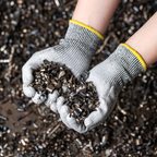 Grey PU-coated glove holding metal swarf