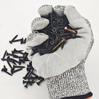 Cut-resistant glove gripping black screws