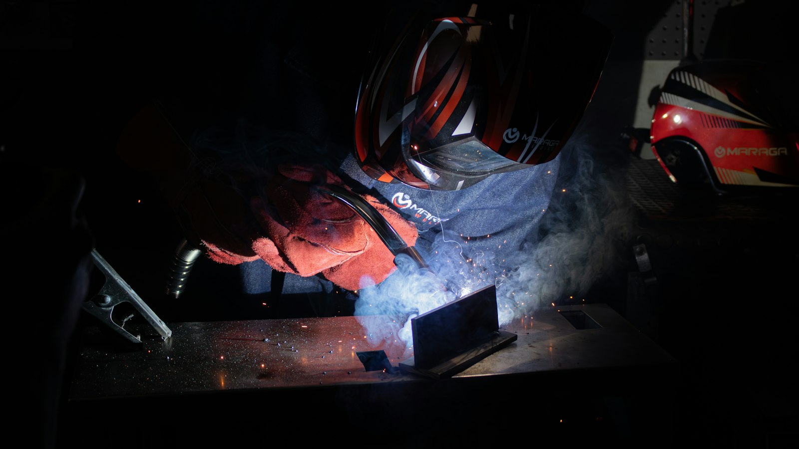 Welder working with sparks in a workshop